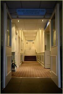 a hallway of an office building with a sign on the ceiling at Anchor Hotel and Seabed Restaurant in Tarbert