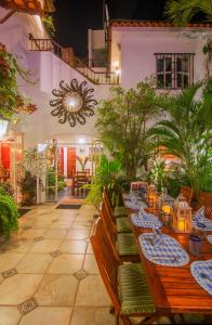 a restaurant with a long table with plates of food at Casa Romance Escondido in Puerto Vallarta