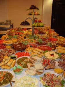 a table topped with lots of different types of food at Hotel Leotar in Trebinje