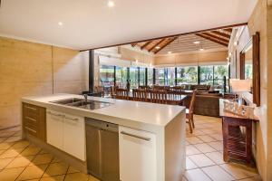 a kitchen with a sink and a dining room at Geographe Cove Resort in Dunsborough