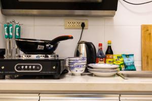 a kitchen counter top with a stove and a sink at XiNing Chengxi ·Wanda square· in Xining