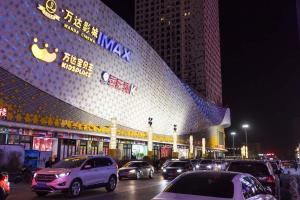 a large building with cars parked in front of it at XiNing Chengxi ·Wanda square· in Xining +12 photos