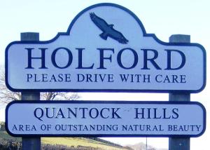 a sign for a hotel with an airplane on it at Combe House Hotel in Holford