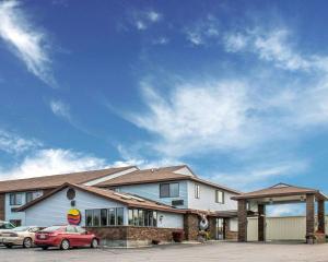 a house with cars parked in front of it at Comfort Inn in Manistique