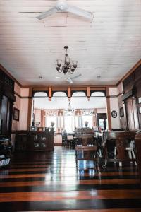a dining room with a ceiling fan and a table at Oasis Balili Heritage Lodge in Tagbilaran City