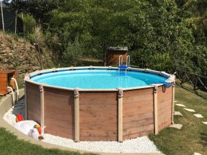 a swimming pool in a yard with a wooden poolvisor at Casa Tucci in Reggello