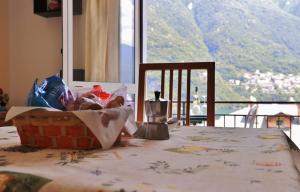 a table with a basket of food on top of it at Appartamenti La Porta sul Lago in Laglio