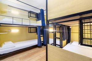 Våningssäng eller våningssängar i ett rum på Nomad's Hub - Best Value Co-living Hostel