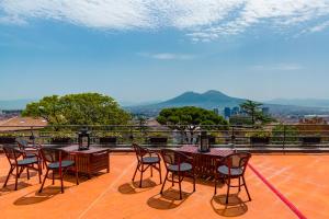 a group of tables and chairs on a balcony at Culture Hotel Villa Capodimonte in Naples