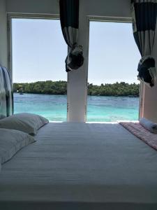 a bedroom with a bed with a view of the ocean at Mr. Bean Resort in Sabang