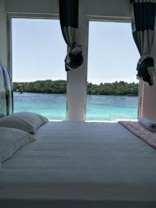 a bedroom with a bed with a view of the ocean at Mr. Bean Resort in Sabang