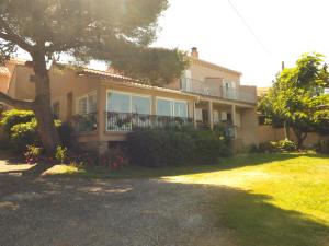 a large house with a tree in front of it at Chambre d hôtes chez raymonde et sandrine in Luri