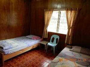 A bed or beds in a room at Bulan And Daud Homestay