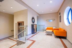 a living room with an orange couch and a table at City Park Hotel in Baku