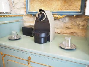 a black and white coffee maker on a blue dresser at Bravissimo Old Side Girona One, cozy apartment in Girona