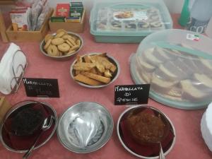 a table topped with different types of food in bowls at Agriturismo Sant'Erasmo in Paterno