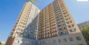 a large apartment building with two tall buildings at Tikas home Апартаменты in Tbilisi City