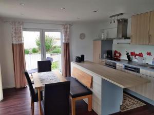 a kitchen with a table and chairs and a dining room at Ferienwohnung Bella Casa in Öhningen