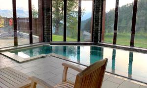 a swimming pool with a view of the mountains at Arc 1950 Manoir Savoie Skis aux pieds in Bourg-Saint-Maurice