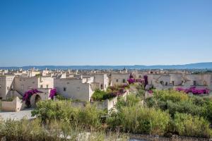 a view of a city with purple flowers at Borgo Egnazia in Savelletri di Fasano