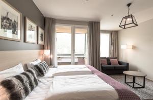 a bedroom with a large bed and a couch at Myrkdalen Resort Hotel in Myrkdalen