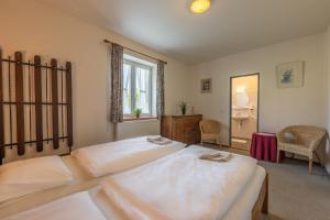 a large bedroom with two beds and a window at Penzion Na Bobrovníku in Lipova Lazne