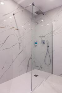 a shower with a glass door in a bathroom at Los Arcos in Nerja