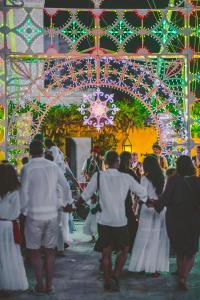 a group of people walking in front of a christmas decoration at Borgo Egnazia in Savelletri di Fasano