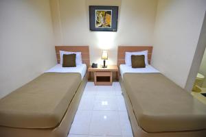 Postel nebo postele na pokoji v ubytování Hotel Graha DPT 33
