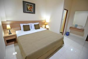 Postel nebo postele na pokoji v ubytování Hotel Graha DPT 33