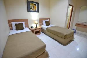 Llit o llits en una habitació de Hotel Graha DPT 33