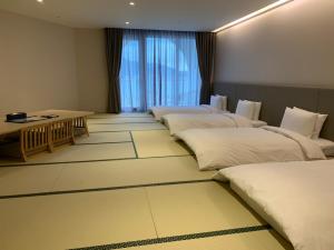 Postel nebo postele na pokoji v ubytování Golden Tulip FAB Hotel New Taipei