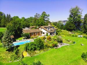 an aerial view of a house with a swimming pool at Lake Villa Lotus in Luzern
