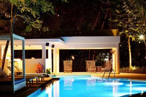 a swimming pool in a backyard at night at Deevana Krabi Resort in Ao Nang Beach