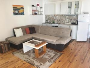 a living room with a couch and a table at Apartment Luna in Ulcinj