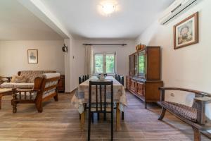 a living room with a table and chairs and a couch at House Gorica in Bar