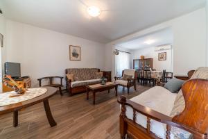 a living room filled with furniture and a table at House Gorica in Bar