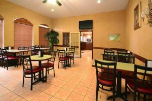a restaurant with tables and chairs in a room at Americas Best Value Inn & Suites San Benito in San Benito