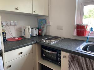 a kitchen with a sink and a stove top oven at Tig Lammax in Macroom