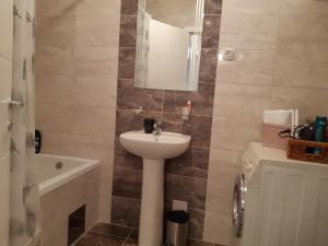 a bathroom with a sink and a mirror at Apartman DIJANA in Banja Luka