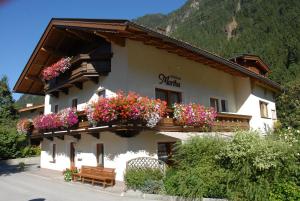 a building with flower boxes on the side of it at Apartment Martha in Mayrhofen