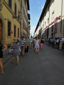 a group of people walking down a street at Ricasoli Charme in Florence