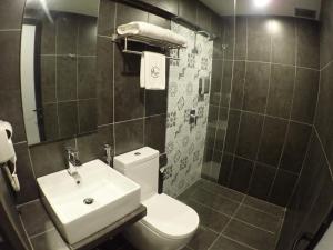 a bathroom with a white toilet and a sink at Apex Boutique Hotel @ Bandar Sunway in Petaling Jaya
