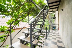 a staircase in a house with a checkered floor at Matini Ratchada 32 in Bangkok