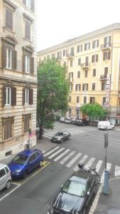a city street with cars parked in a parking lot at Nova Roma Guest House in Rome