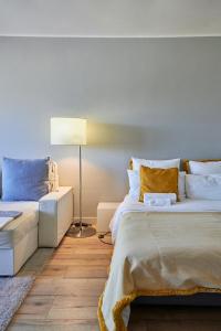 a bedroom with two beds and a lamp at BEACHFRONT Cascais,Estoril Apartment in Estoril