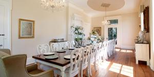 a dining room with a long table and chairs at Belle Air Mansion and Inn in Nashville