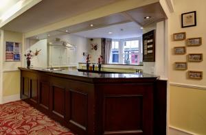 a large kitchen with a large wooden counter top at Fisher's Hotel in Pitlochry