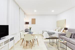 a white living room with a bed and a couch at LEEWAYS LOFT XXXI in GRAN VÍA in Madrid