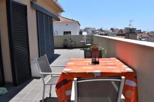 a orange table and chairs on a balcony at SUNSET PENTHOUSE SITGES in Sitges